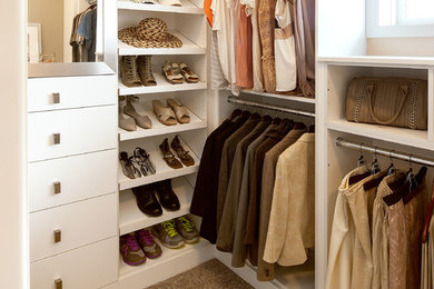 This is an example of a mid-sized transitional gender-neutral walk-in wardrobe in Sacramento with flat-panel cabinets, white cabinets, carpet and brown floor.