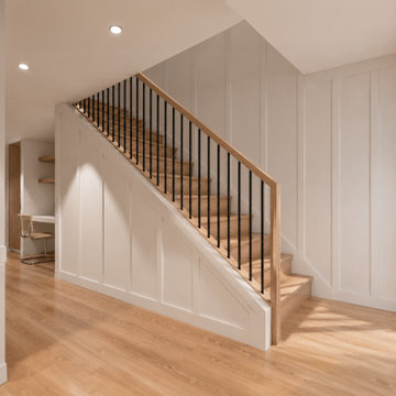 Modern White Oak Staircase with Board and Batten Paneling