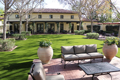 This is an example of a large mediterranean drought-tolerant and full sun backyard brick garden path in Orange County.
