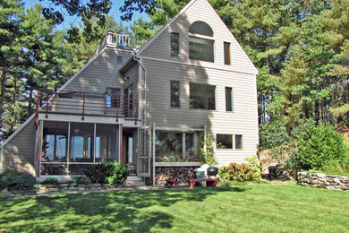 Inspiration for a mid-sized modern three-storey beige house exterior in Boston with wood siding and a shed roof.