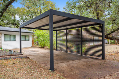 Example of a mid-sized detached one-car carport design in Austin