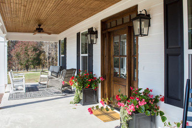 Mid-sized country front door in Other with white walls, concrete floors, a single front door, a dark wood front door and white floor.