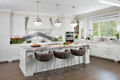 Design ideas for a mid-sized transitional l-shaped open plan kitchen in Toronto with recessed-panel cabinets, white cabinets, grey splashback, dark hardwood floors, with island, an undermount sink, stone slab splashback and stainless steel appliances.