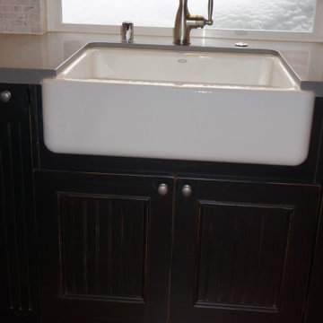 Whimsical Tahoe Cottage - Custom farmhouse sink set in pop-out cabinet