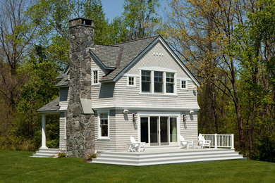 Photo of a two-storey grey exterior in Portland Maine with mixed siding.