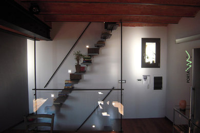 This is an example of a small modern floating staircase in Milan with open risers.