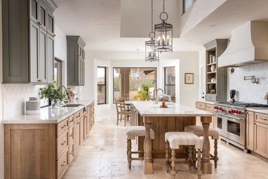 Inspiration for a large southwestern eat-in kitchen remodel in Phoenix with shaker cabinets, light wood cabinets, quartzite countertops and an island