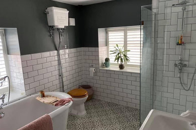 Inspiration for a medium sized victorian grey and white bathroom in Other with freestanding cabinets, a freestanding bath, a walk-in shower, a two-piece toilet, white tiles, metro tiles, grey walls, ceramic flooring, grey floors, an open shower, a single sink and a freestanding vanity unit.
