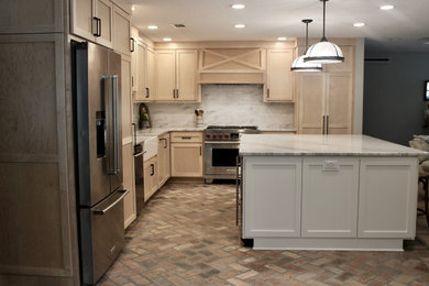 Mid-sized country l-shaped brick floor and red floor open concept kitchen photo in Other with a farmhouse sink, shaker cabinets, light wood cabinets, quartzite countertops, white backsplash, marble backsplash, stainless steel appliances, an island and white countertops