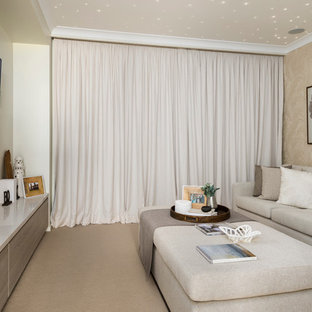 Inspiration for a mid-sized contemporary enclosed carpeted home theater remodel in Newcastle - Maitland with beige walls and a wall-mounted tv