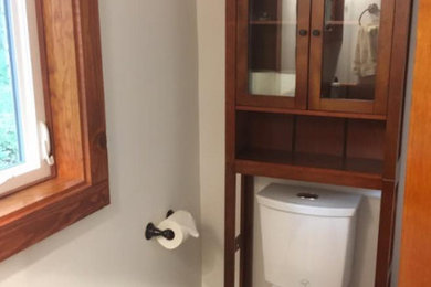 Small elegant multicolored floor powder room photo in Seattle with a two-piece toilet and white walls