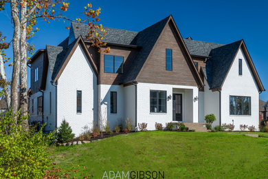 Huge eclectic white two-story brick and clapboard exterior home photo in Indianapolis with a shingle roof and a gray roof