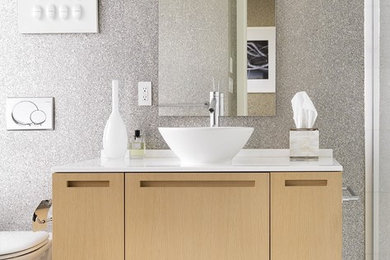 Example of a trendy gray tile bathroom design in Vancouver with a vessel sink, flat-panel cabinets and light wood cabinets