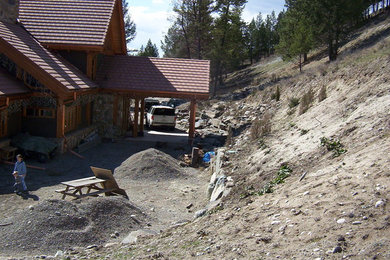 Design ideas for a huge full sun courtyard brick retaining wall landscape in Vancouver for summer.