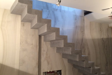 Small modern concrete staircase in London with concrete risers.