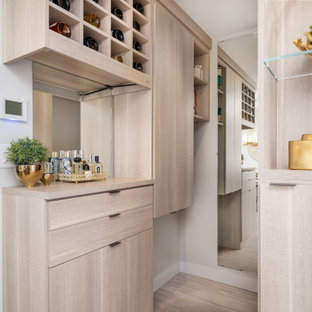 Small eclectic vestibule in Calgary with grey walls, laminate floors, a single front door, a black front door and grey floor.