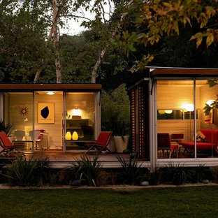 Inspiration for a small modern study in Los Angeles with beige walls, medium hardwood flooring and a freestanding desk.