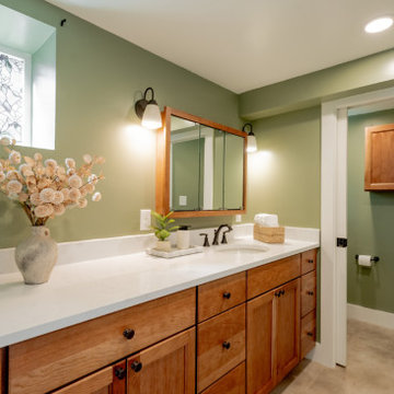 Functional Family Basement Bathroom with Extended Vanity and Sage Green Walls