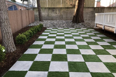 Synthetic turf and paver checkerboard patio
