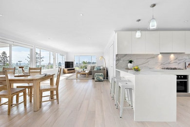 Design ideas for a large beach style open plan dining in Sydney with grey walls, light hardwood floors and multi-coloured floor.