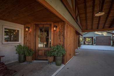 Large rustic green two-story mixed siding exterior home idea in Austin with a metal roof