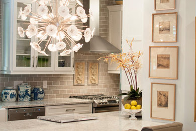 Inspiration for a small eclectic galley light wood floor and beige floor open concept kitchen remodel in Jacksonville with a farmhouse sink, shaker cabinets, white cabinets, quartz countertops, gray backsplash, subway tile backsplash, stainless steel appliances and an island