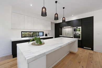 Photo of a modern kitchen in Melbourne with with island.