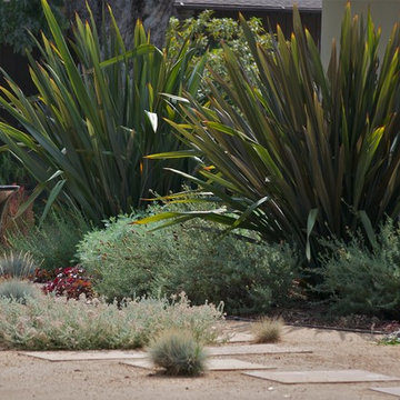 Water feature fountain provides interest to Mediterranean front entry