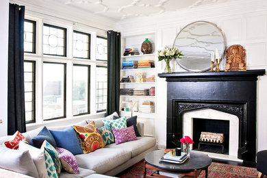 Photo of a mid-sized eclectic living room in Chicago with white walls, a standard fireplace and a stone fireplace surround.