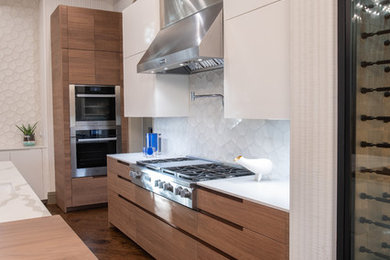 Photo of a large contemporary u-shaped separate kitchen in Dallas with a single-bowl sink, flat-panel cabinets, light wood cabinets, quartz benchtops, white splashback, cement tile splashback, panelled appliances, medium hardwood floors, with island, brown floor and white benchtop.