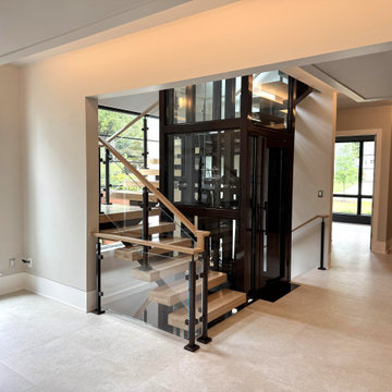 Project #136 | Modern Floating Staircase Encircling Glass Elevator