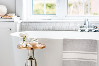 Example of a large transitional master gray tile and mosaic tile marble floor bathroom design in Montreal with recessed-panel cabinets, white cabinets, a one-piece toilet, gray walls, an undermount sink and quartz countertops