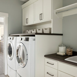 Traditional single-wall separated utility room in Minneapolis with a built-in sink, shaker cabinets, white cabinets, wood worktops, grey walls, a side by side washer and dryer and brown worktops.