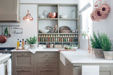 Inspiration for a large contemporary l-shaped brown floor eat-in kitchen remodel in Denver with a farmhouse sink, shaker cabinets, beige cabinets, white backsplash, stainless steel appliances and an island
