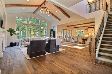 Inspiration for a huge craftsman medium tone wood floor and brown floor entryway remodel in Portland with beige walls and a dark wood front door