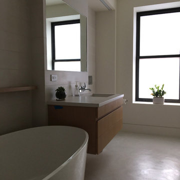 Concrete bathroom finishes - tiles, floor, sink.Private residence - Manhattan.