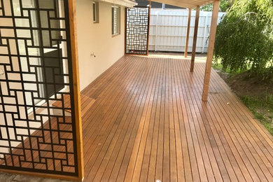 Photo of a mid-sized contemporary backyard deck in Melbourne with a pergola.