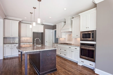 Inspiration for a timeless l-shaped eat-in kitchen remodel in Other with a double-bowl sink, white cabinets, granite countertops, white backsplash, ceramic backsplash, stainless steel appliances and an island