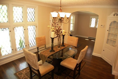 Mid-sized elegant dark wood floor enclosed dining room photo in Cleveland with beige walls