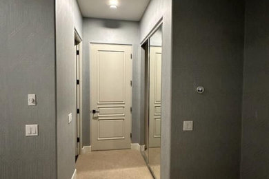 Example of a mid-sized mountain style guest marble floor, red floor, wallpaper ceiling and wallpaper bedroom design in Miami with gray walls and no fireplace