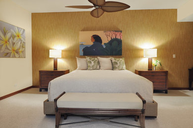 Photo of a large tropical master bedroom in Hawaii with beige walls, carpet, no fireplace and beige floor.