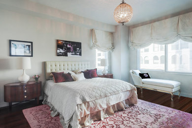 Example of a mid-sized trendy master medium tone wood floor bedroom design in New York with beige walls and no fireplace