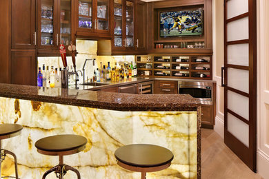 Transitional u-shaped medium tone wood floor and beige floor seated home bar photo in San Francisco with shaker cabinets, dark wood cabinets, beige backsplash and stone slab backsplash