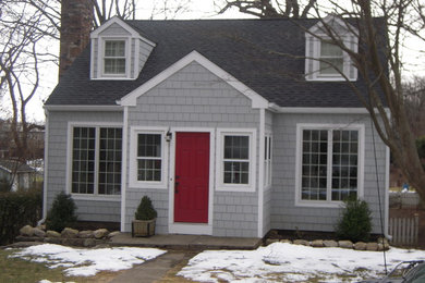 Inspiration for a small timeless gray split-level wood exterior home remodel in New York with a shingle roof