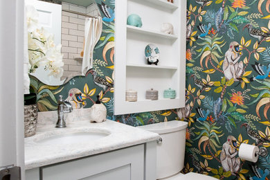 Bathroom - small eclectic kids' blue tile and mosaic tile ceramic tile, green floor, single-sink and wallpaper bathroom idea in Other with shaker cabinets, white cabinets, a two-piece toilet, multicolored walls, an undermount sink, quartz countertops, white countertops and a freestanding vanity