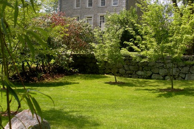 Photo of a mid-sized traditional partial sun backyard formal garden in Bridgeport.