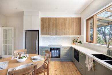Inspiration for a country l-shaped kitchen pantry in Adelaide with shaker cabinets, medium wood cabinets and white benchtop.
