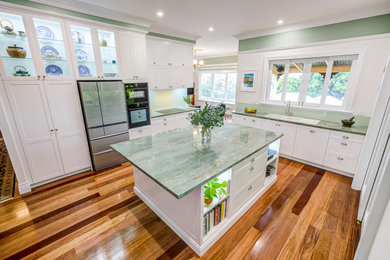 Photo of an expansive traditional l-shaped separate kitchen in Brisbane with shaker cabinets, white cabinets, quartzite benchtops, with island and green benchtop.