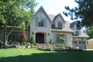 Inspiration for a large timeless gray two-story stone exterior home remodel in Toronto with a shingle roof