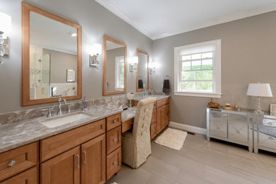 Large transitional master white tile and porcelain tile porcelain tile, gray floor and double-sink corner shower photo in Boston with raised-panel cabinets, light wood cabinets, a one-piece toilet, gray walls, an undermount sink, quartz countertops, a hinged shower door, beige countertops, a niche and a built-in vanity